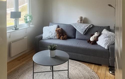 a living room with a couch with teddy bears on it at 2 Bedroom Awesome Home In Tyringe in Tyringe
