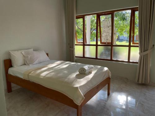 Ένα ή περισσότερα κρεβάτια σε δωμάτιο στο Rumah Budaya Sumba