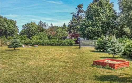 a yard with a sandbox in the grass at Beautiful Stacaravan In Smoldzino in Gardna Wielka