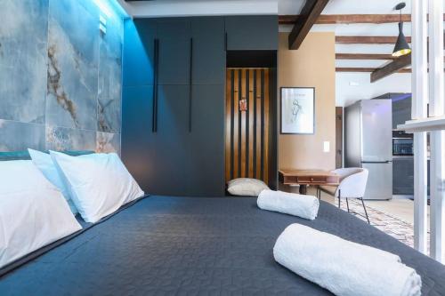 a large bed with two pillows on it in a room at Vp & Lo 1 Residence in Corfu