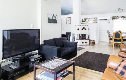 a living room with a flat screen tv and a couch at 5 Bedroom Lovely Home In Kleppe in Orre