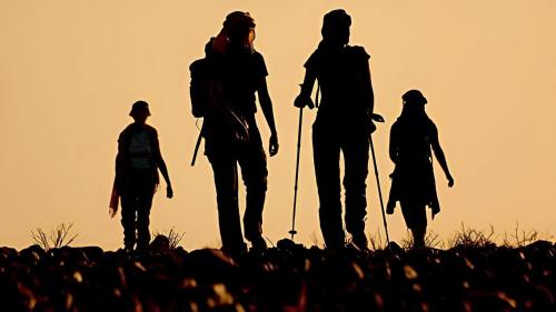a group of people walking on a hill at sunset at Casa Vacanze Mare Gargano in Rodi Garganico