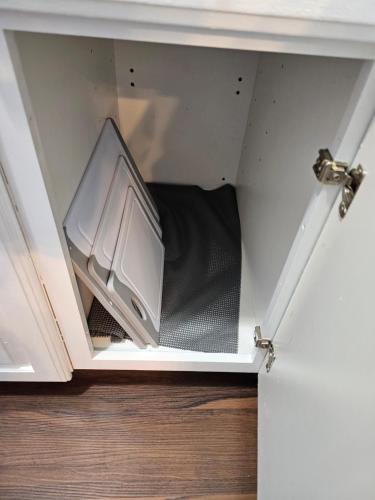 a drawer in a closet with a tv in it at Newly Renovated Historic 6-BR Manor plus 1-BR Apt, Where Timeless Elegance Meets Modern Luxury in Onancock