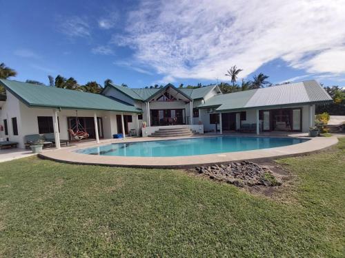 a house with a swimming pool in the yard at Bularangi Villa, Fiji in Rakiraki
