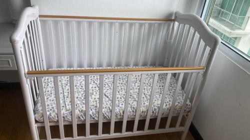 a white crib in a room with a window at Bay Resort Condominium, 7, Beach-front Sea view, 6-8 PAX in Miri