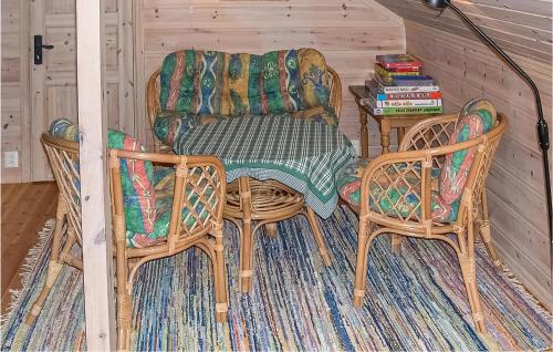a room with a chair and two chairs and a table at Holiday Home Vinje Skjærdalen in Vågsli
