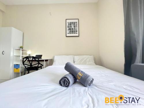 a white bed with a rolled up towel on it at Youth City Residence Family Suite KLIA AEON Mall Nilai USIM in Nilai