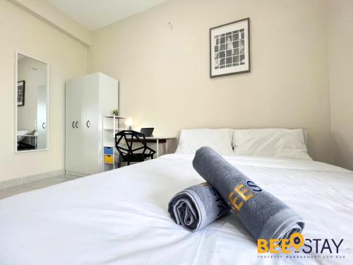 a bed with two rolled towels on top of it at Youth City Residence Family Suite KLIA AEON Mall Nilai USIM in Nilai