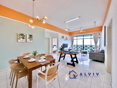 a dining room and living room with a table and chairs at Costa Mahkota - 1min I Mahkota Parade Mall I Dataran Pahlawan I Mahkota Hospital in Melaka