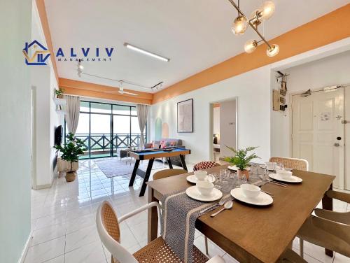 a dining room and living room with a table and chairs at Costa Mahkota - 1min I Mahkota Parade Mall I Dataran Pahlawan I Mahkota Hospital in Melaka