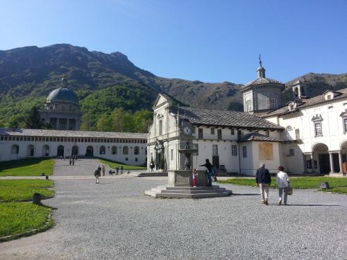 a group of people walking in front of a building at Santuario di Oropa in Biella