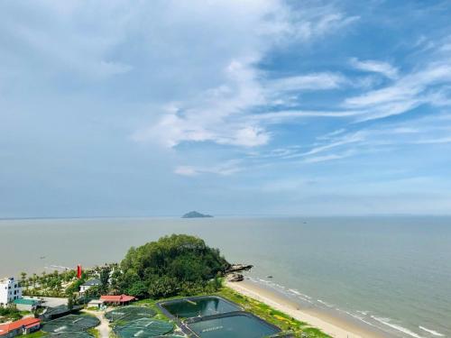 a view of a beach with a swimming pool at Ibiza Hải Tiến in Xã Trảng Bôm