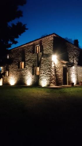 a stone building with lights on it at night at Terrazza sul Chianti in Greve in Chianti