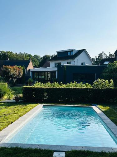 a swimming pool in the yard of a house at Nice house with swimming pool near Maastricht in Bunde
