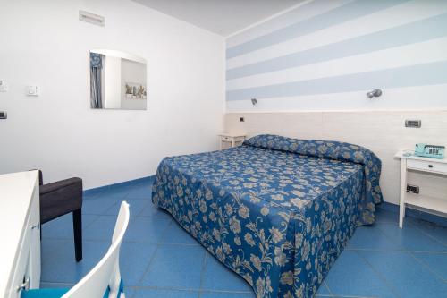 a small room with a bed and a desk at Hotel La Sorgente in Savelletri di Fasano
