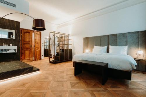 a bedroom with a large bed and a table at META SUITES historic city living in Bolzano