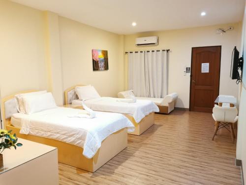 a hospital room with two beds and a tv at Acrige Apartelle at heart of Bogo City, Cebu in Banban