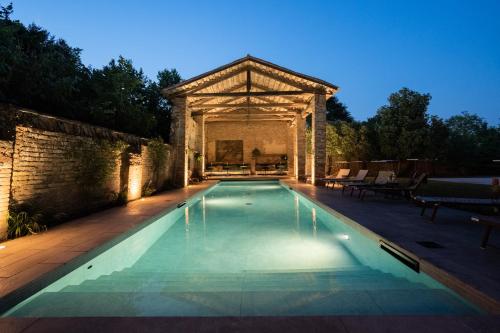 a swimming pool with a gazebo in a backyard at Glamping Canonici di San Marco in Mirano