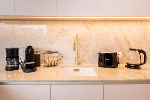 a kitchen counter with a sink and appliances on it at Lifestyle Apartments Dante in Bardolino
