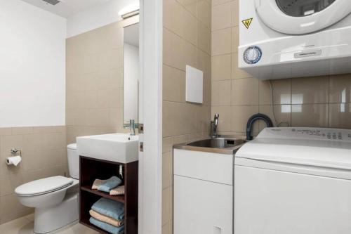 a small bathroom with a sink and a toilet at The Lookout - Mount Maunganui in Mount Maunganui