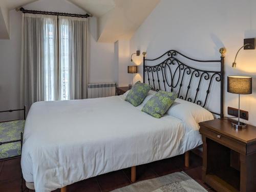 a bedroom with a white bed and a table with a lamp at Hotel Apartamento Marouco in A Guarda