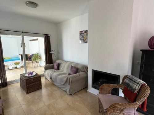 a living room with a couch and a fireplace at Villa Maravilla in Murcia