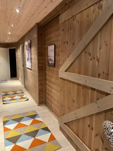 a room with wooden walls and a staircase with a rug at ChaletMons, stor trivelig leilighet i Myrkdalen in Vossestrand