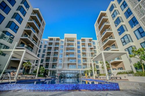 an image of an apartment building with a swimming pool at Juman flat Marina and Sea view in Ḩayl Āl ‘Umayr