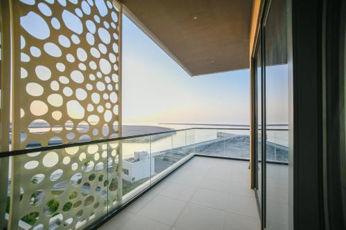 a view of the ocean from the balcony of a house at Juman flat Marina and Sea view in Ḩayl Āl ‘Umayr