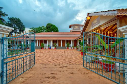 a gate in front of a building with a store at Portu Stay Goa in Vagator