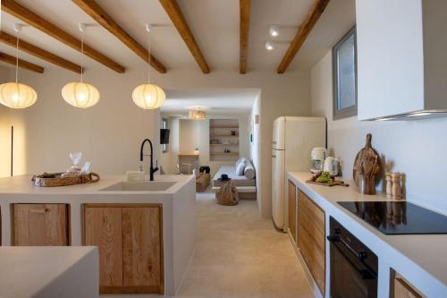 a kitchen with a sink and a refrigerator at casa elysian in Agios Romanos