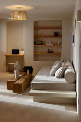 a bedroom with a bed and a table in it at casa elysian in Agios Romanos