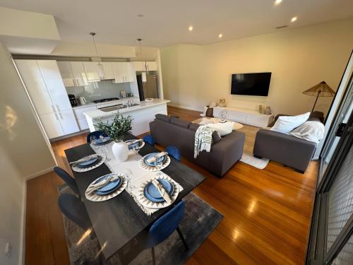 a living room with a table and a couch at City & Beach Retreat in Newport