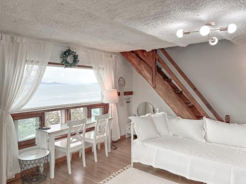 a living room with a white couch and a table at Country House Exclamation Mark & Comma in Namhae