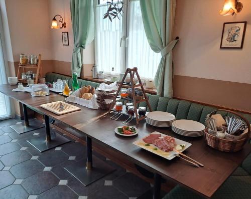 a wooden table with food on top of it at Pension Waldviertel in Groß-Siegharts