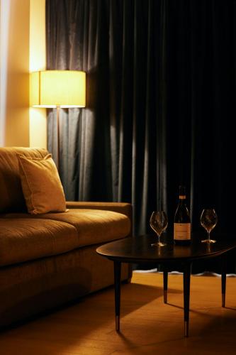 a living room with a couch and a table with wine glasses at NOHGA HOTEL UENO TOKYO in Tokyo