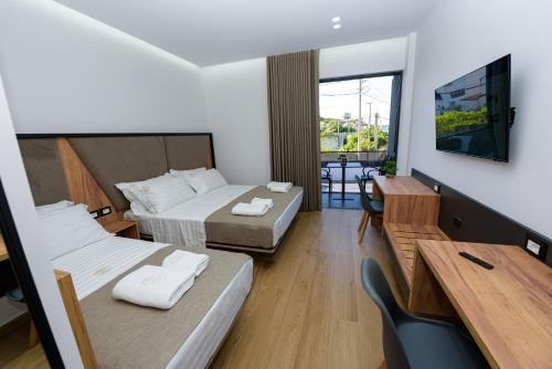 Postel nebo postele na pokoji v ubytování Kevin's ApartHotel