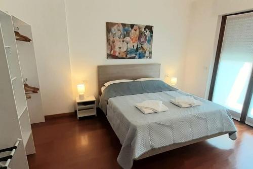 a bedroom with a bed with two pillows on it at Casa Olimpia 52 in Verona