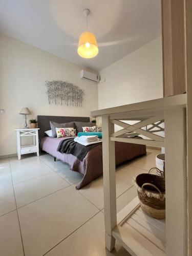 a living room with a bed and a table at Colibri seafront villa with pool in Nopíyia