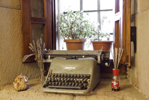 an old typewriter sitting on a table next to a window at Casa Velarde in Torrelavega
