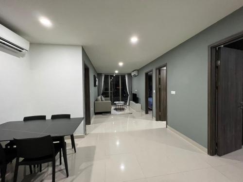 a dining room with a table and chairs at The PeAk Residence, Multi-Apartment by Emma in Phnom Penh