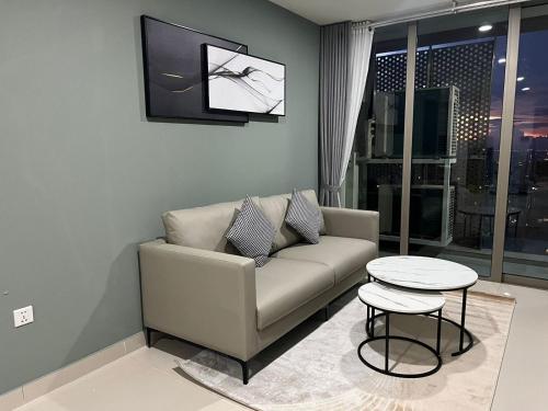 a living room with a couch and a table at The PeAk Residence, Multi-Apartment by Emma in Phnom Penh
