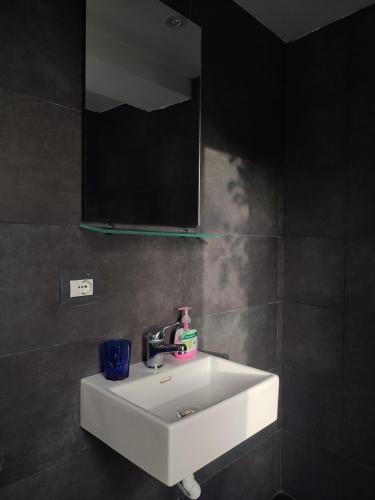 a bathroom with a white sink and a mirror at Villa Janilla in Dhërmi