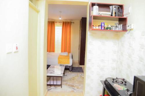 a small room with a bed and a small room with a room at Studio Apartment near the Airport in Nairobi