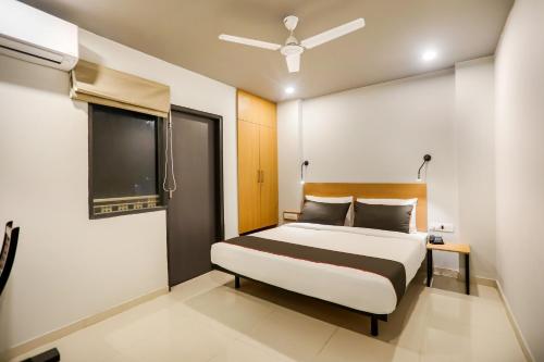 a bedroom with a bed and a flat screen tv at Collection O Le Noida Hotel Near Sector 76 Metro Station in Noida
