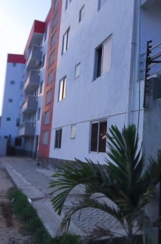 a building with a palm tree in front of it at Studio Apartment near the Airport in Nairobi