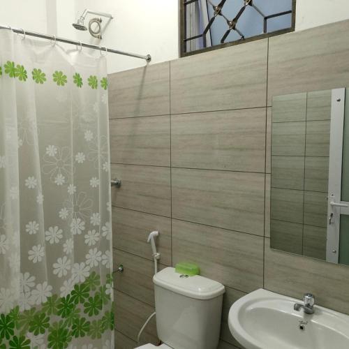a bathroom with a toilet and a sink at Studio Apartment near the Airport in Nairobi