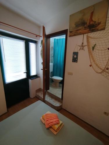 a room with a bathroom with a toilet and a mirror at Rooms Tia in Baška Voda