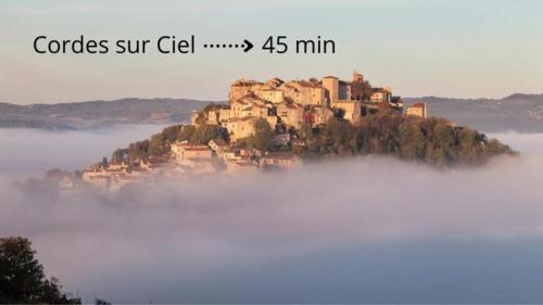 an island in the middle of a field of fog at T2 Cosy - 70m2 au Coeur de ville in Graulhet