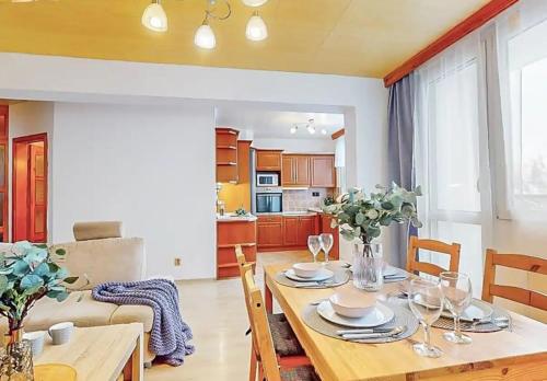 a kitchen and dining room with a table and chairs at Apartment in center of Poděbrady in Nymburk